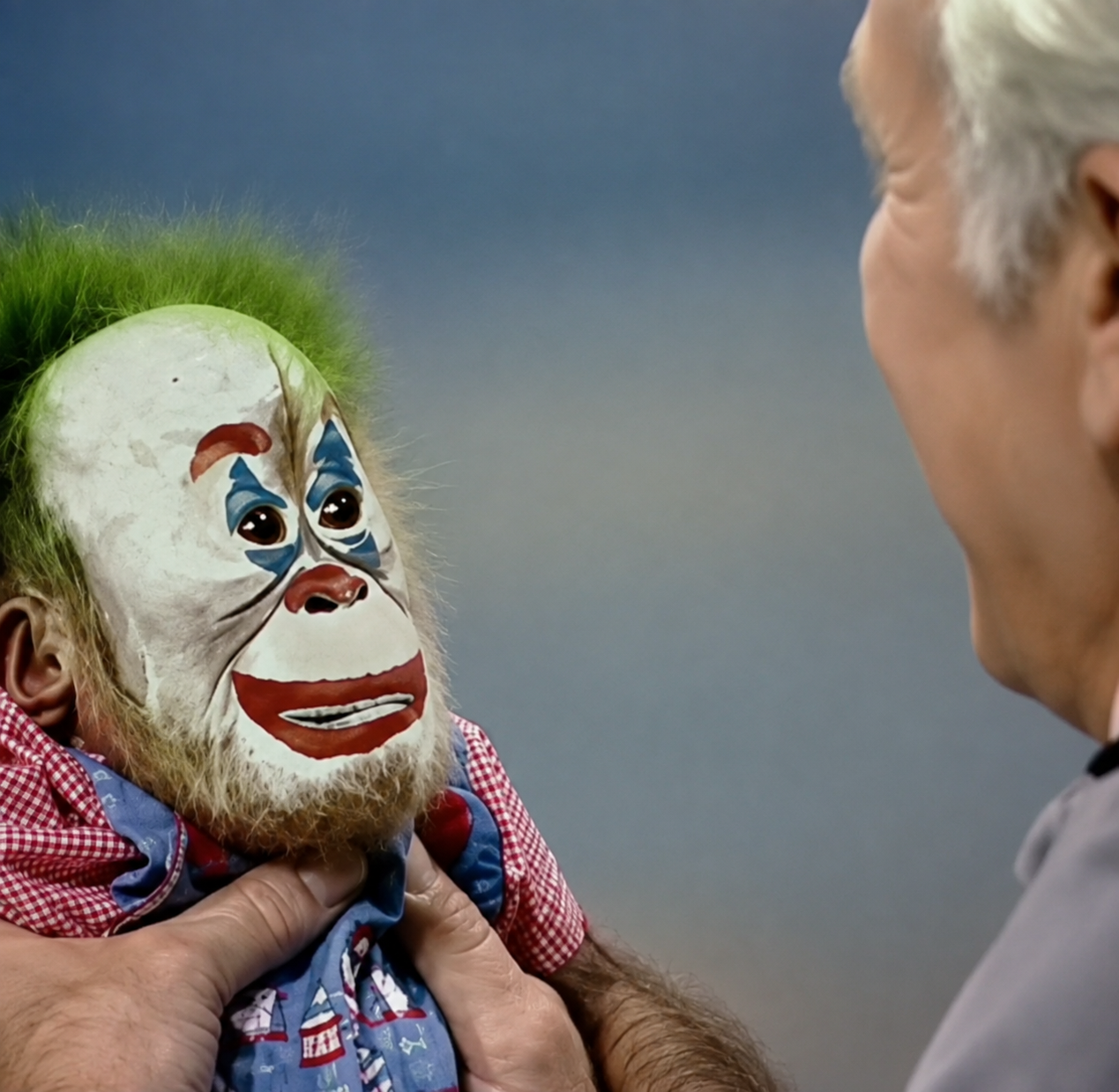 APEONCIRCUS mascot with a melancholy painted circus face